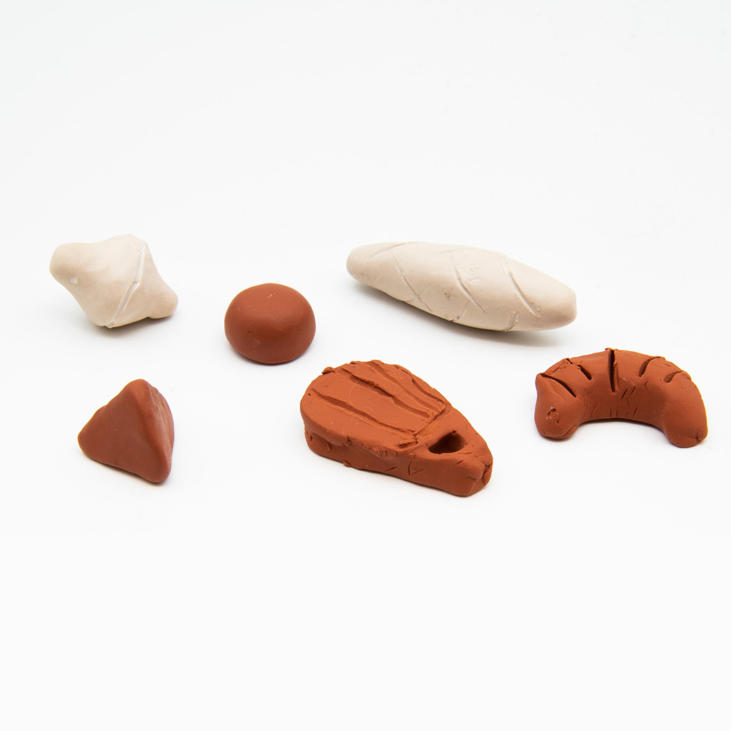 An arrangment of white and brown clay tokens on a white background