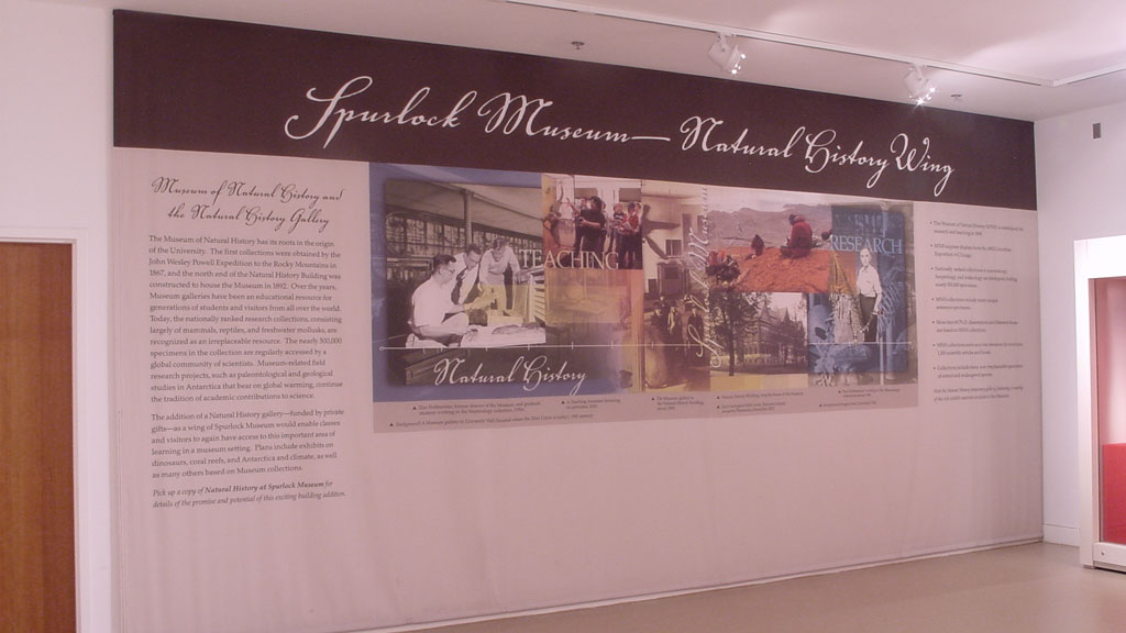 view of wall that says Spurlock Museum&mdash;Natural History Wing with a collage of images and text explaining the wing