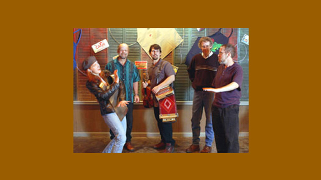 People chatting with Dennis Stroughmatt and his band