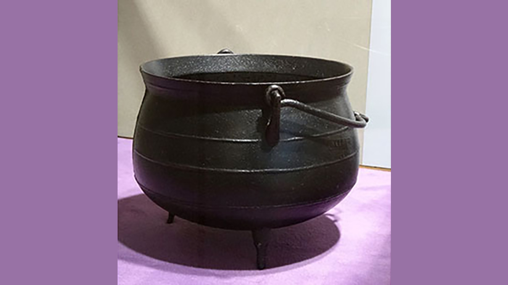 large round black pot on a purple background