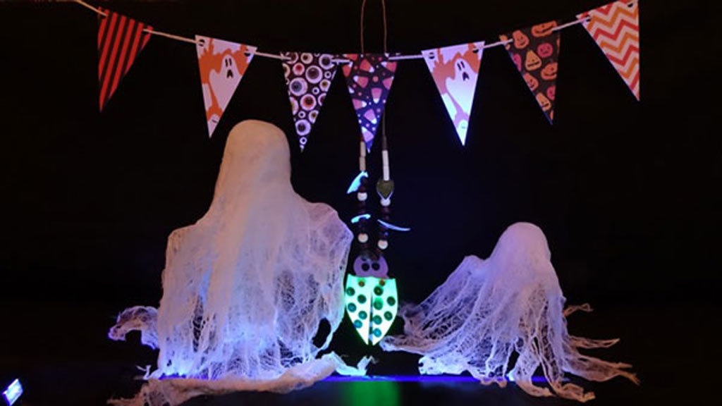 Creepy photo of cheesecloth ghosts and beetle necklaces