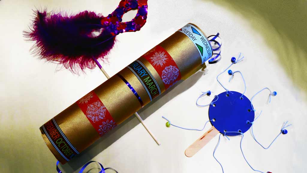 Several crafts including a decorated time capsule made from a cardboard tube, a mask, and a simple hand drum.