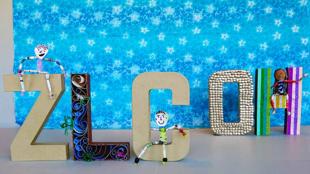 paper bead figures sitting on a ZLC OH craft