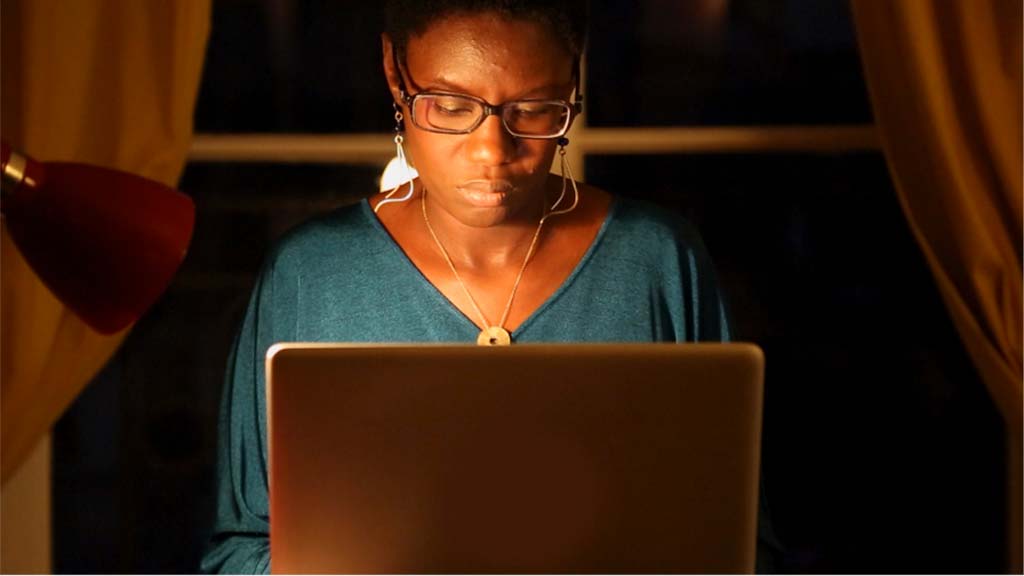 a woman sitting in front of her laptop