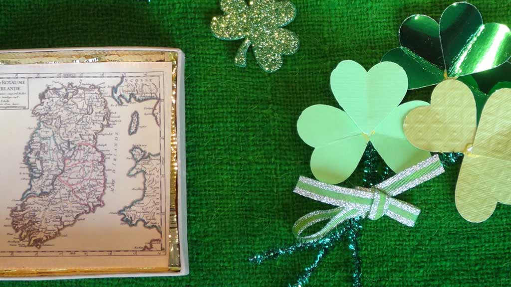 shamrocks and map of ireland on green background