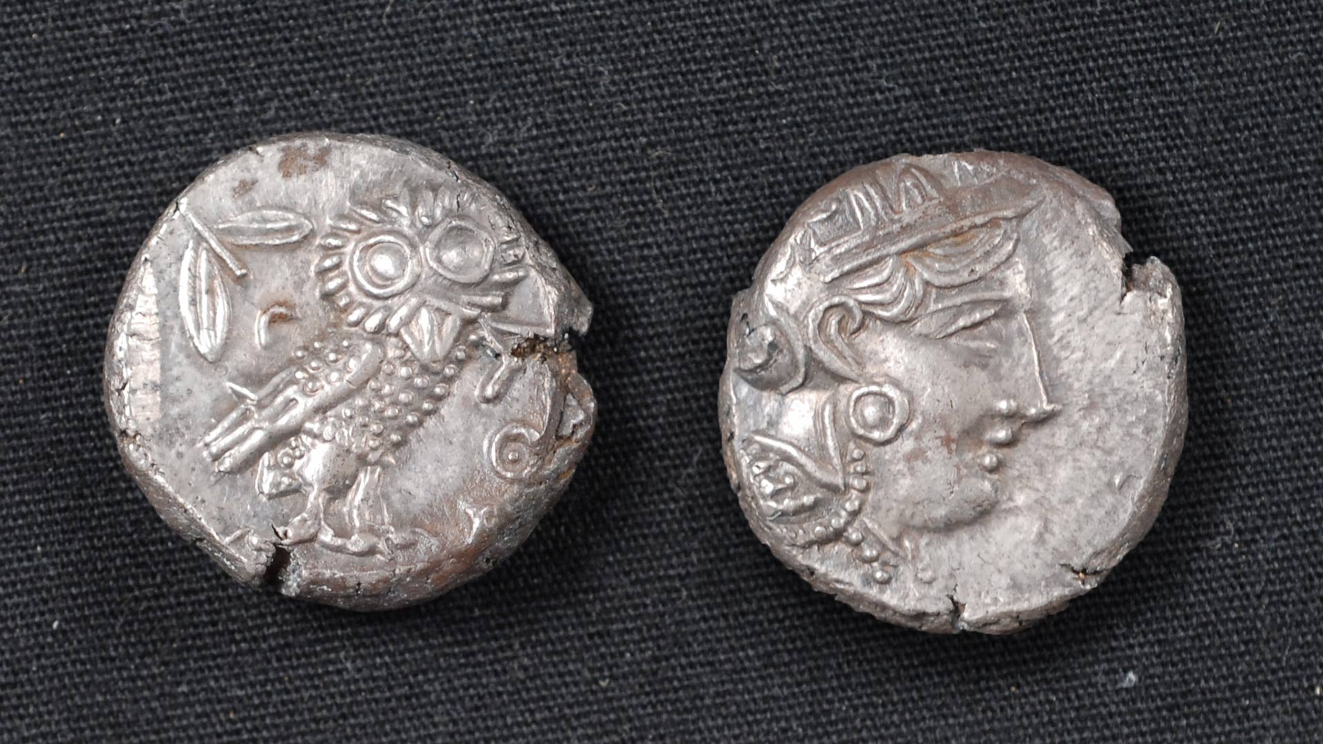 Two Ancient Athenian coins, one featuring an image the Owl of Athena, the other featuring an image of a person