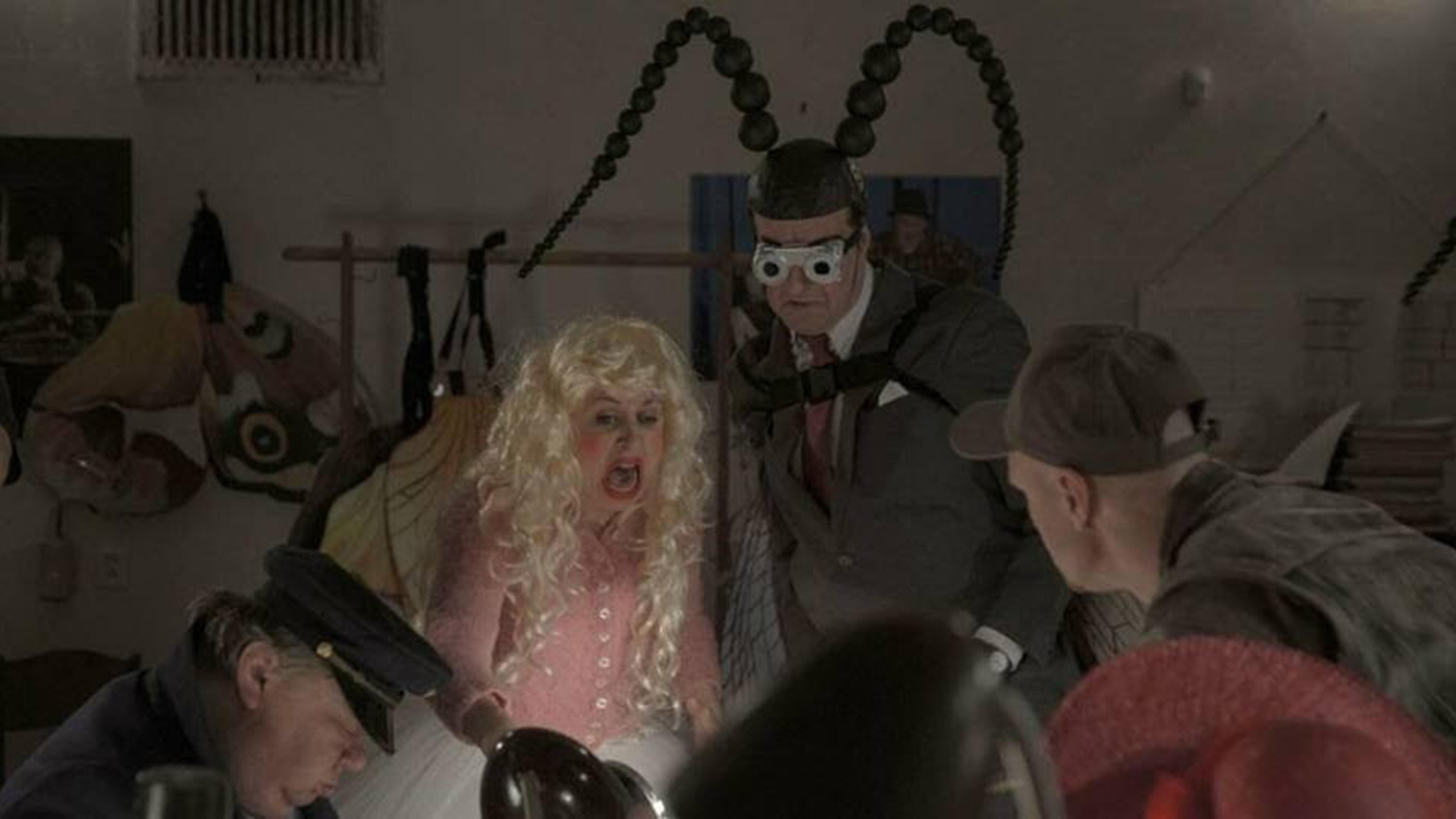 people in insect costumes gathered together