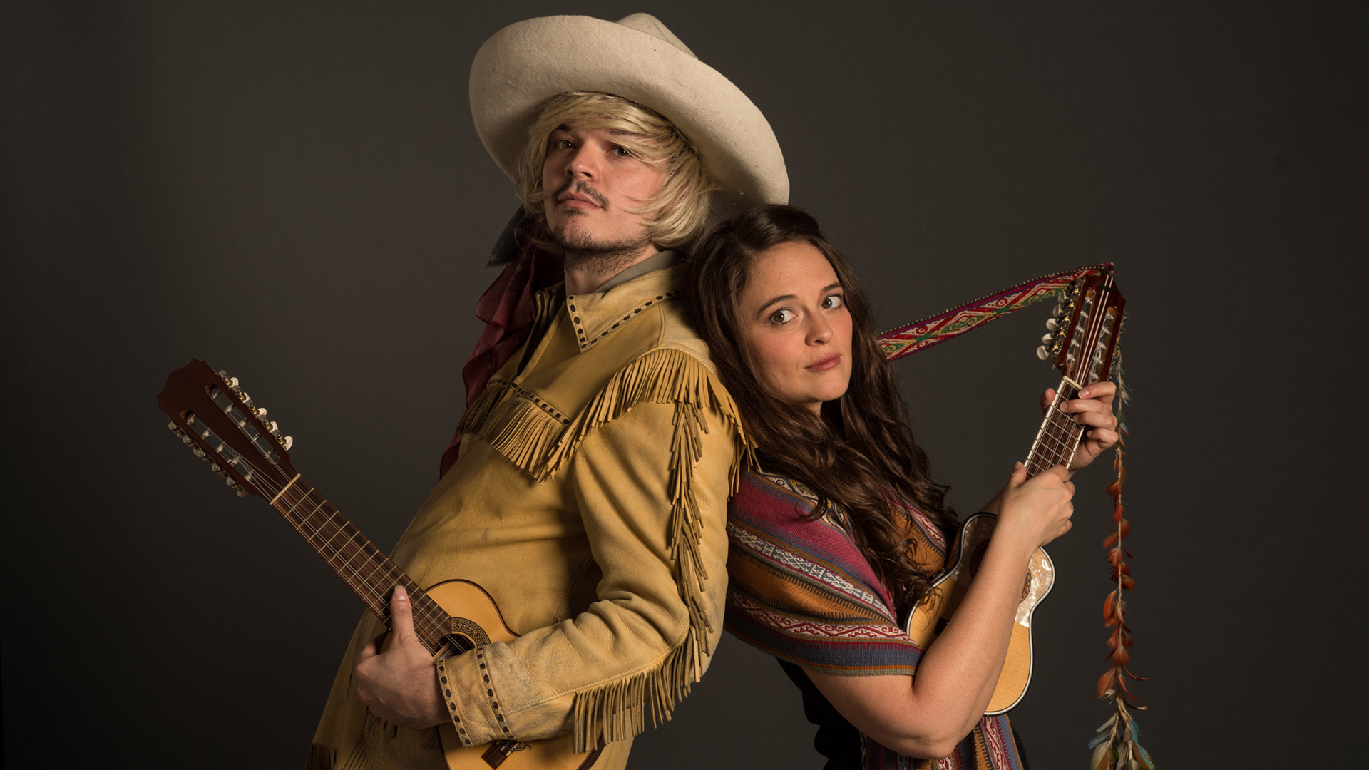 Kate and James Hathaway back to back holding their instruments