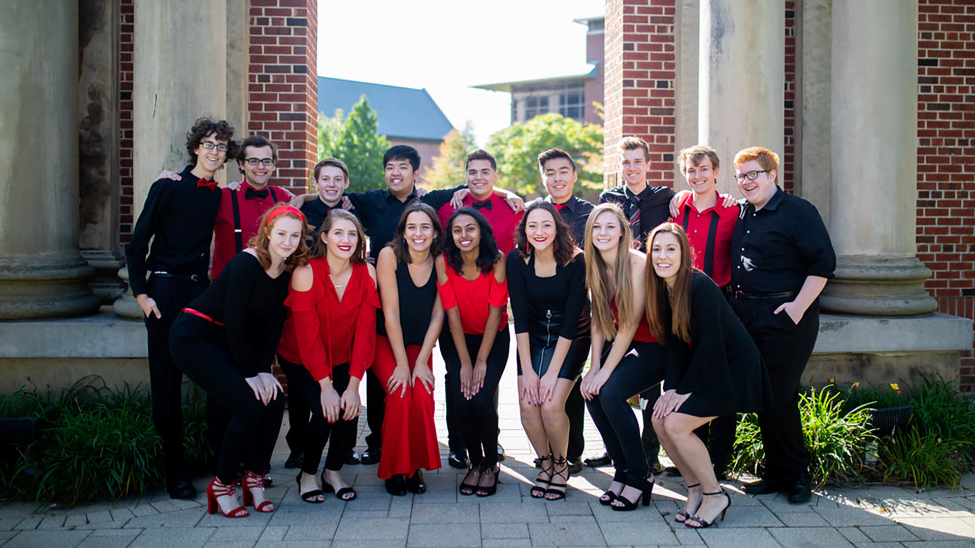 group shot of No Strings A Cappella in a forest