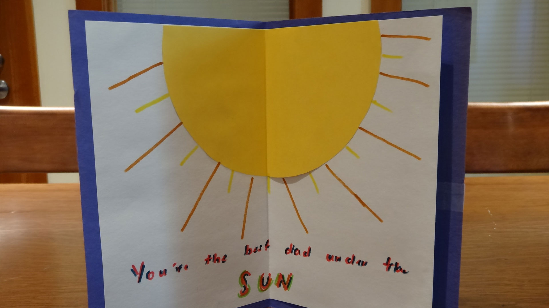 a handmade greeting card with a large sun and the message 