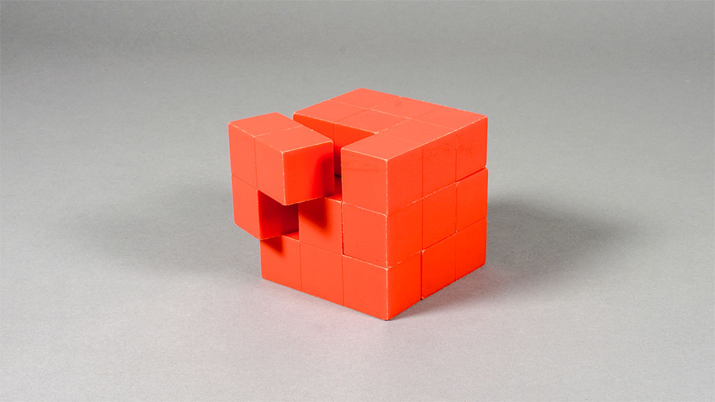 Red puzzle cube with one piece slightly askew