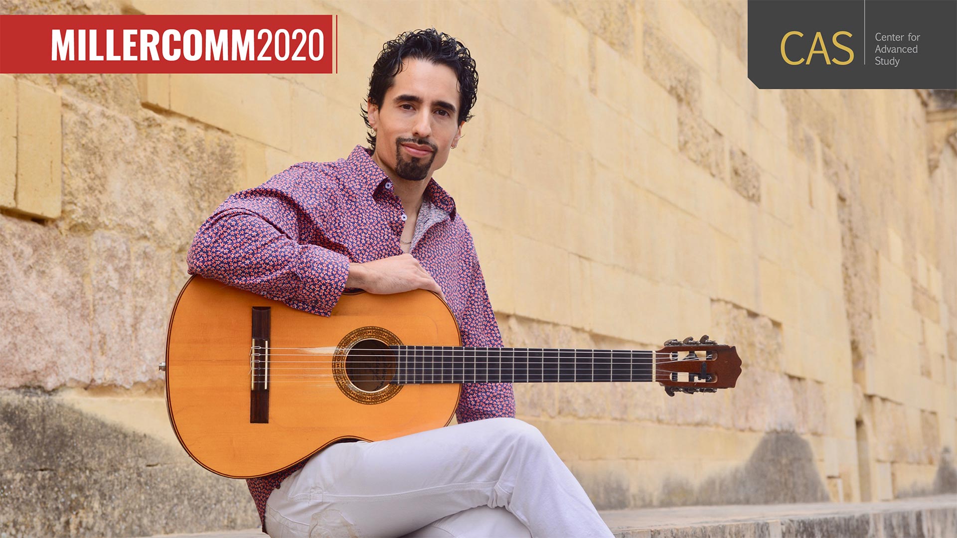 guitarist with collared shirt poses for camera outdoors in front of old limestone wall