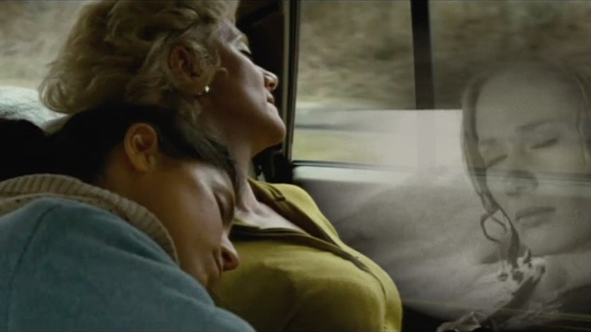 A Woman resting on another woman's shoulder in the backseat of a car. A black and white image of another woman is overlayed on the right side.