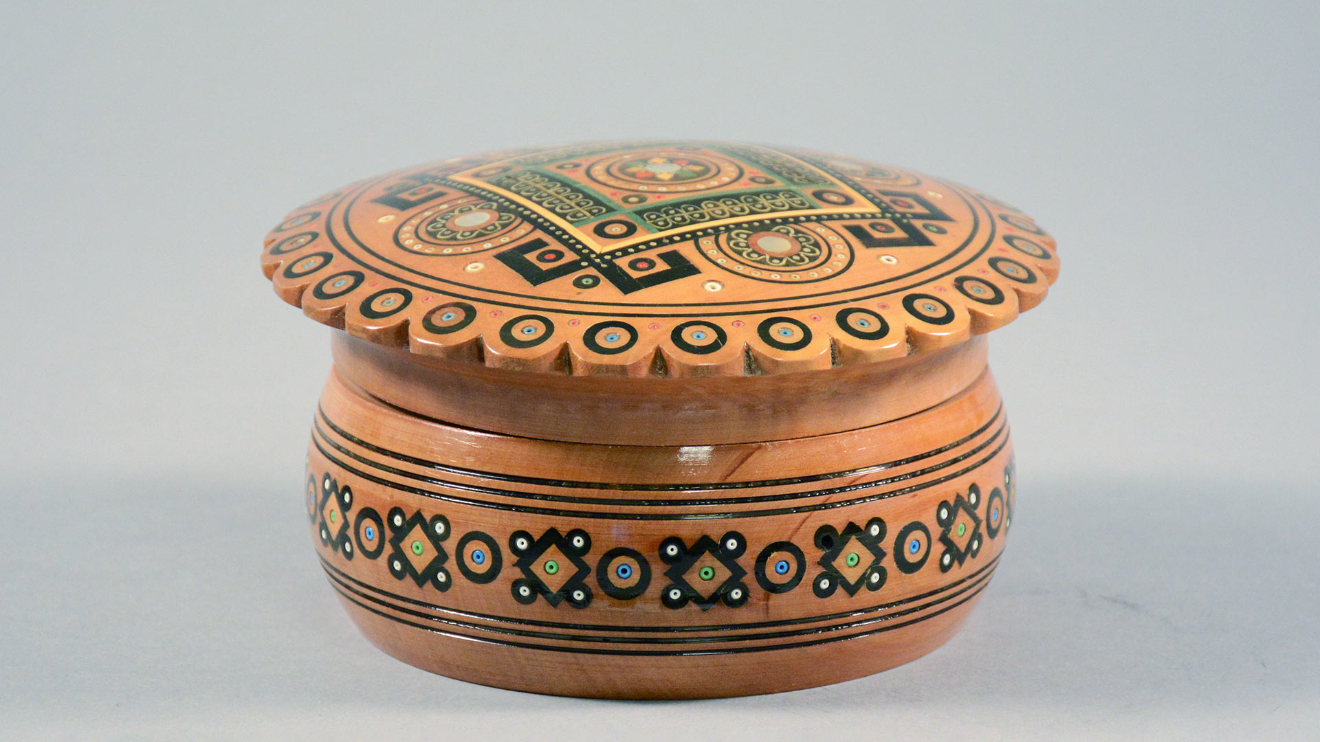 light brown Ukrainian wooden lidded container with painted geometric pattern