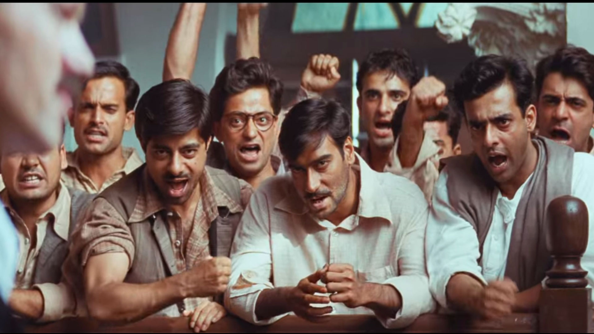 scene from Legend of Bhagat Singh movie where a group of men are staring and shouting in a court room