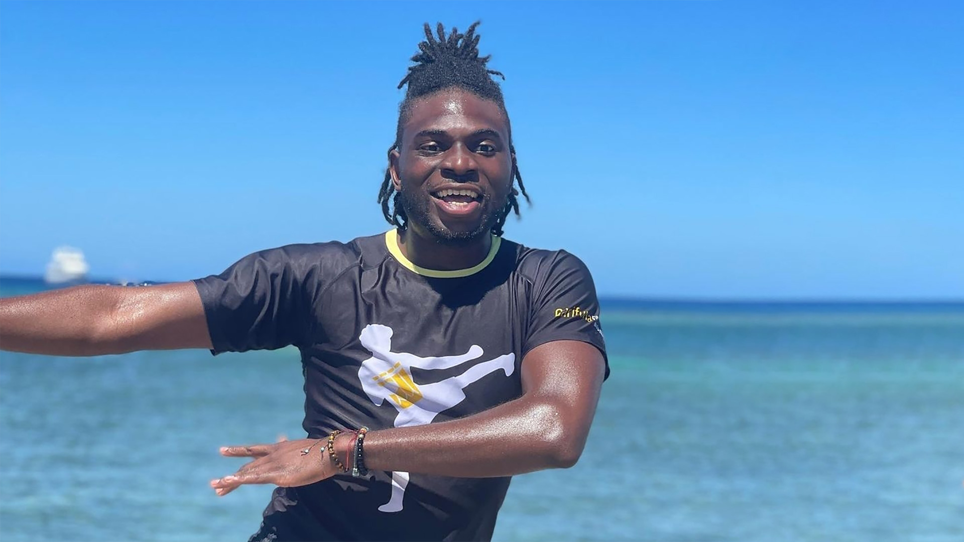 man dancing in front of the ocean