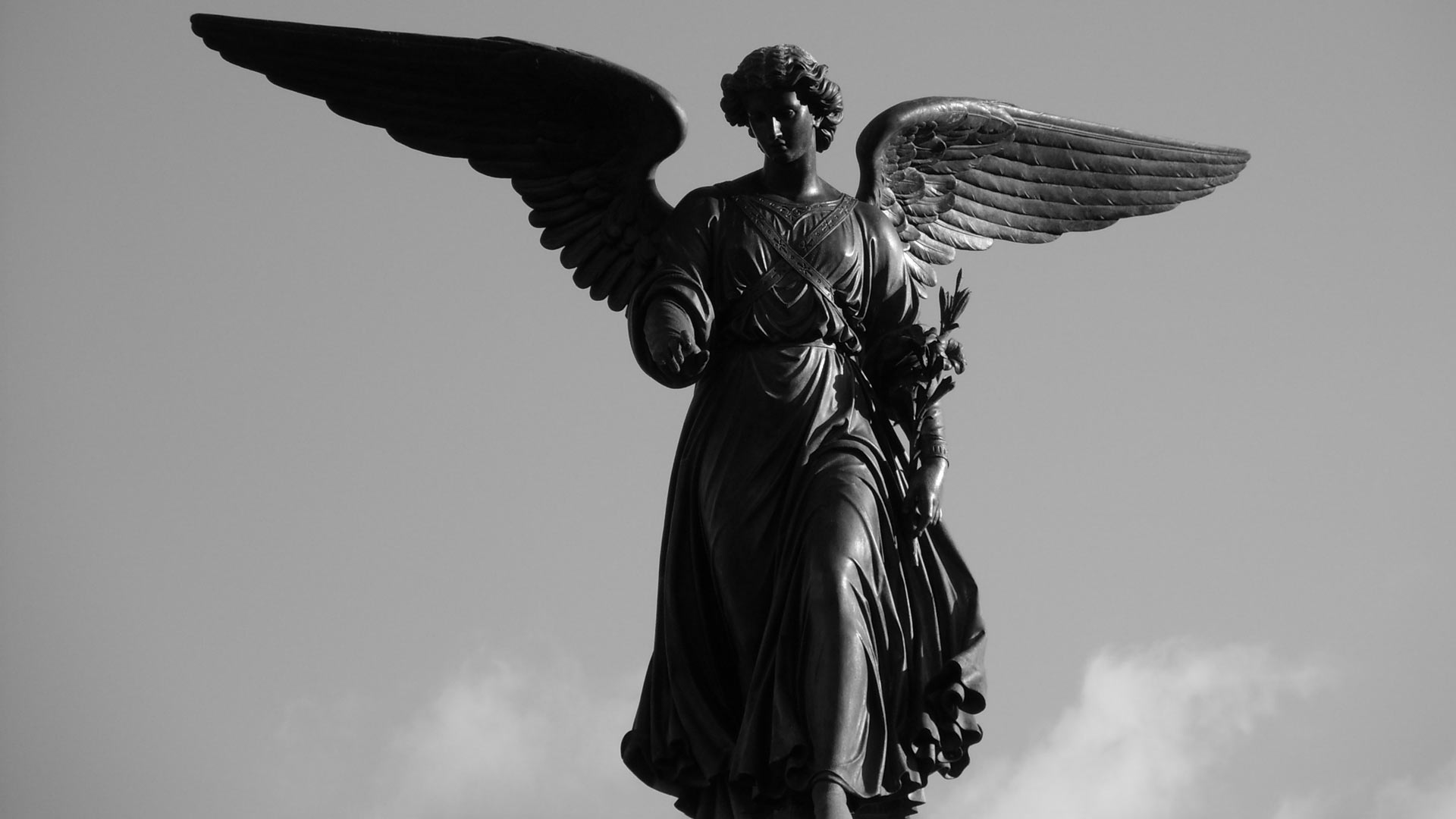 black and white photo of a statue of an angel 