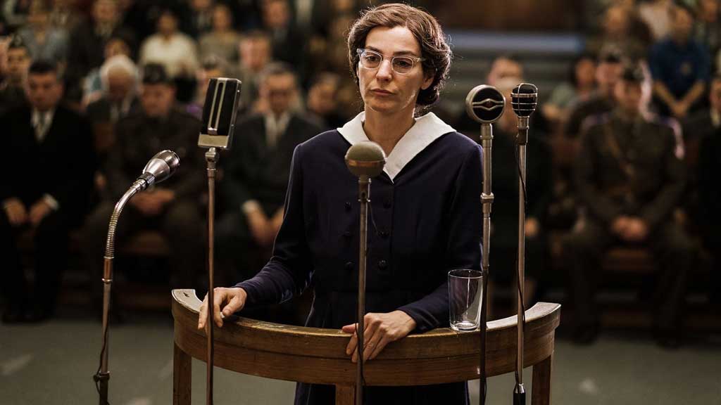 woman standing in front of several microphones