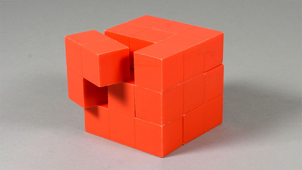 red puzzle cube with one piece askew