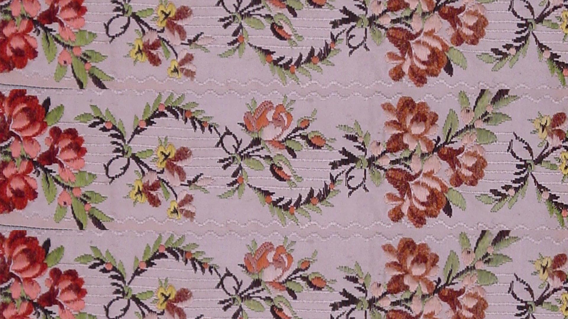 a textile pattern of red and yellow flowers
