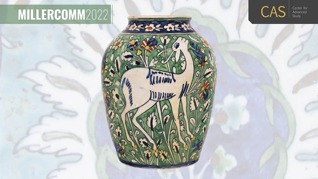 green ceramic vase with white goat surrounded by flowers