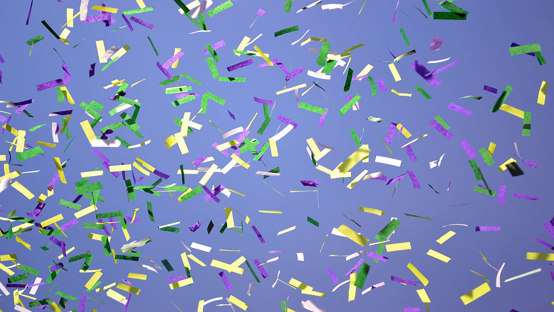 gold, green, and silver metallic confetti falling