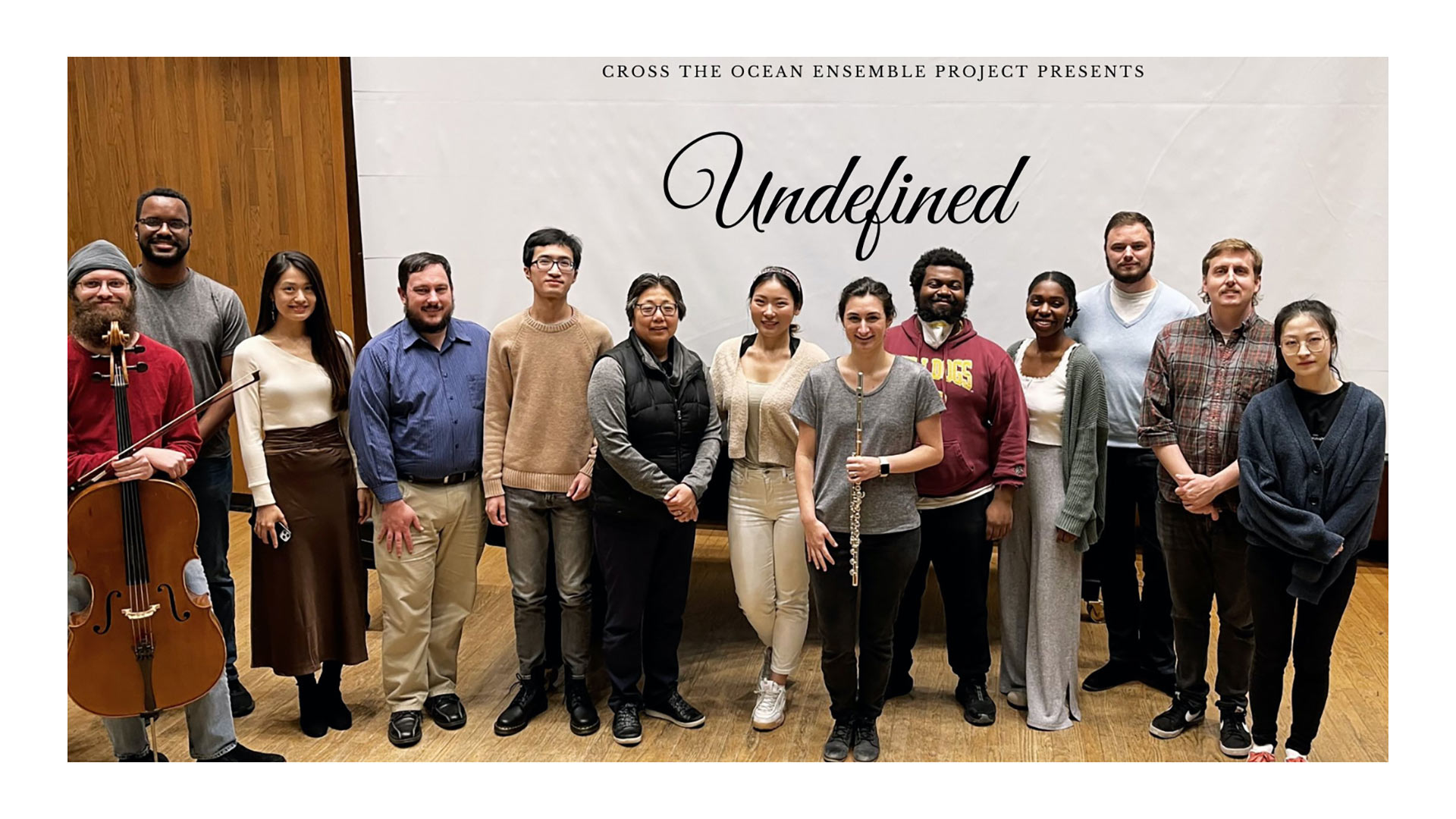 Members of Ocean Ensemble members standing in front of Undefined banner