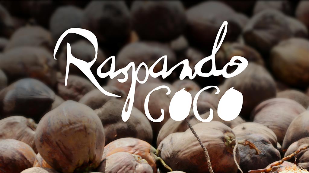 white text that reads "raspando coc" on top of an image of coconuts