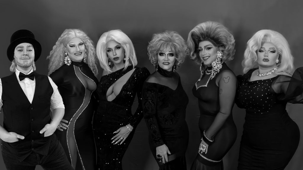 black and white photo of a group of 6 drag queens in full drag
