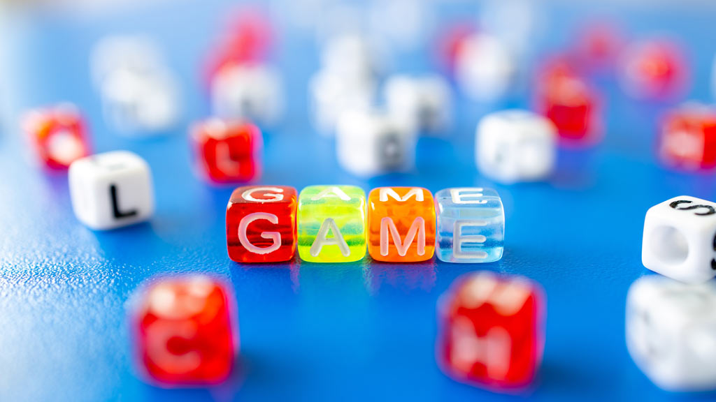 multicolored diced laid out to spell "GAME"