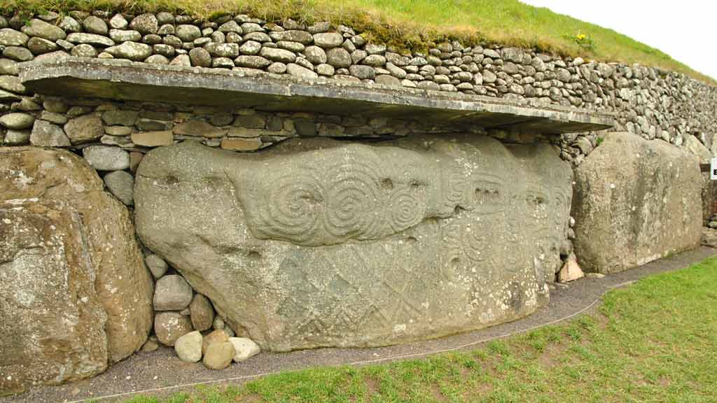 Large stones stacked against a grassy hill