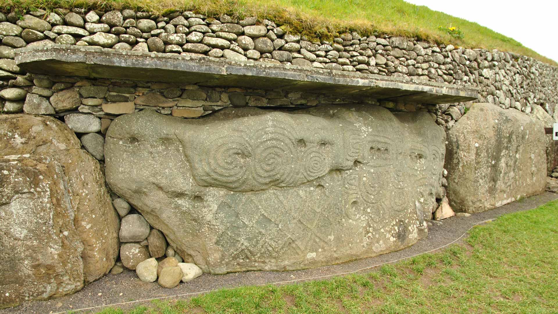 Large stones stacked against a grassy hill