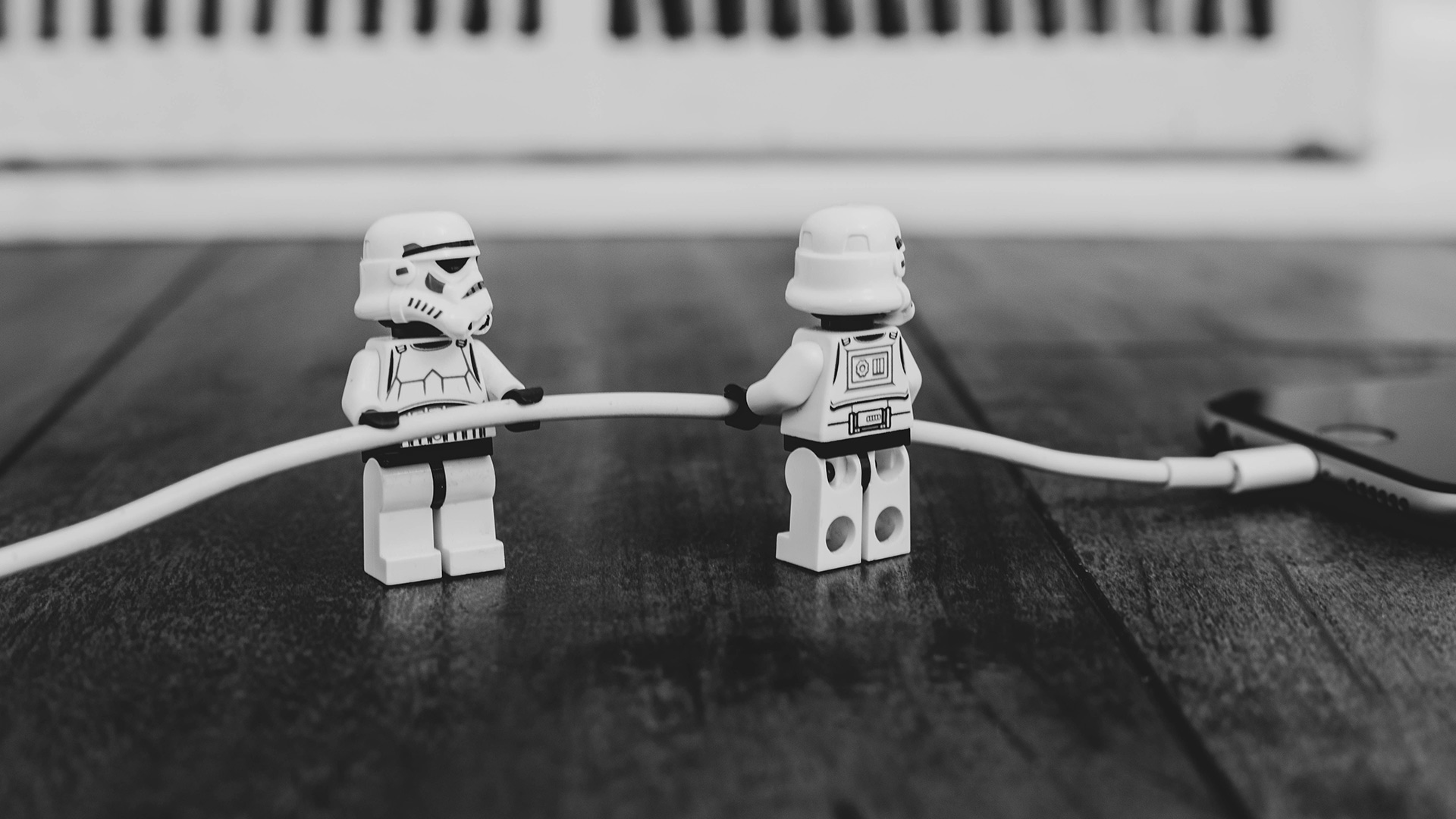 grayscale photography of two Lego mini figurines