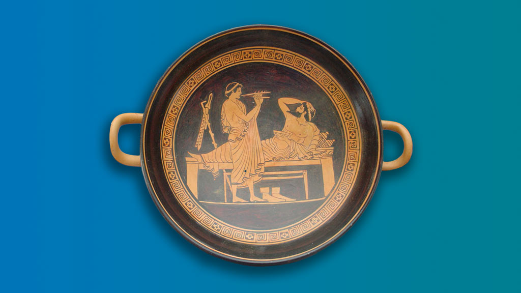 A brown and orange bowl with two handles depicting a man playing an instrument and another laying down on a gradient background