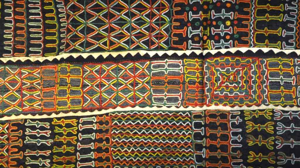 A close-up of a Wodaabe fabric, with a multicolored geometric embroidered pattern