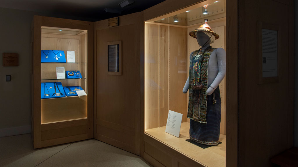 An overview of the exhibit case, featuring a mannequin wearing Wodaabe garments, and various pieces of Tuareg jewelry