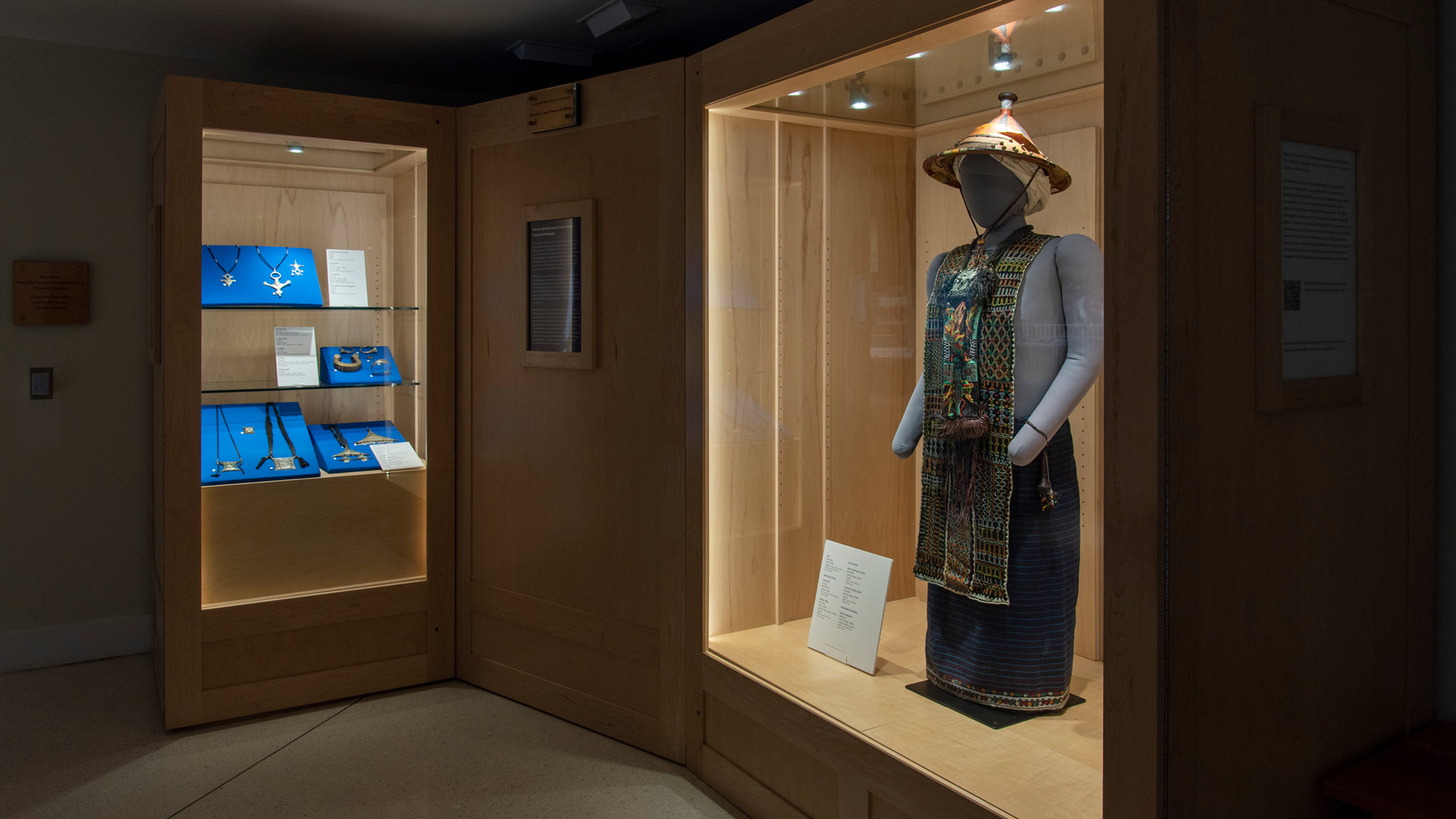 An overview of the exhibit case, featuring a mannequin wearing Wodaabe garments, and various pieces of Tuareg jewelry