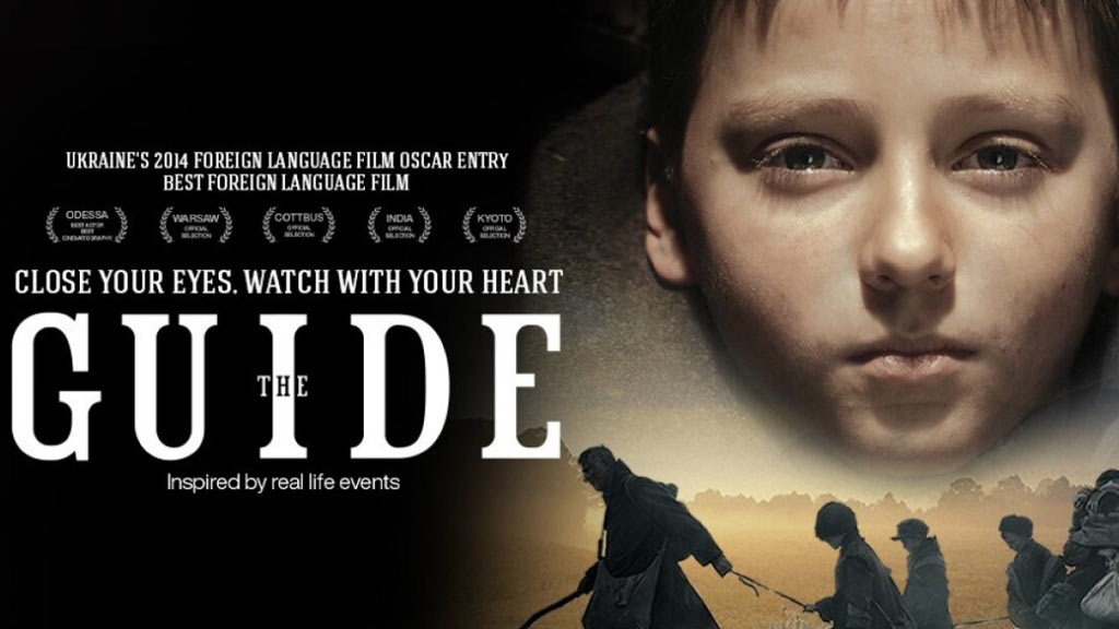 The Guide movie poster with a solemn faced boy in front and four silhouettes of people being led across a landscape.