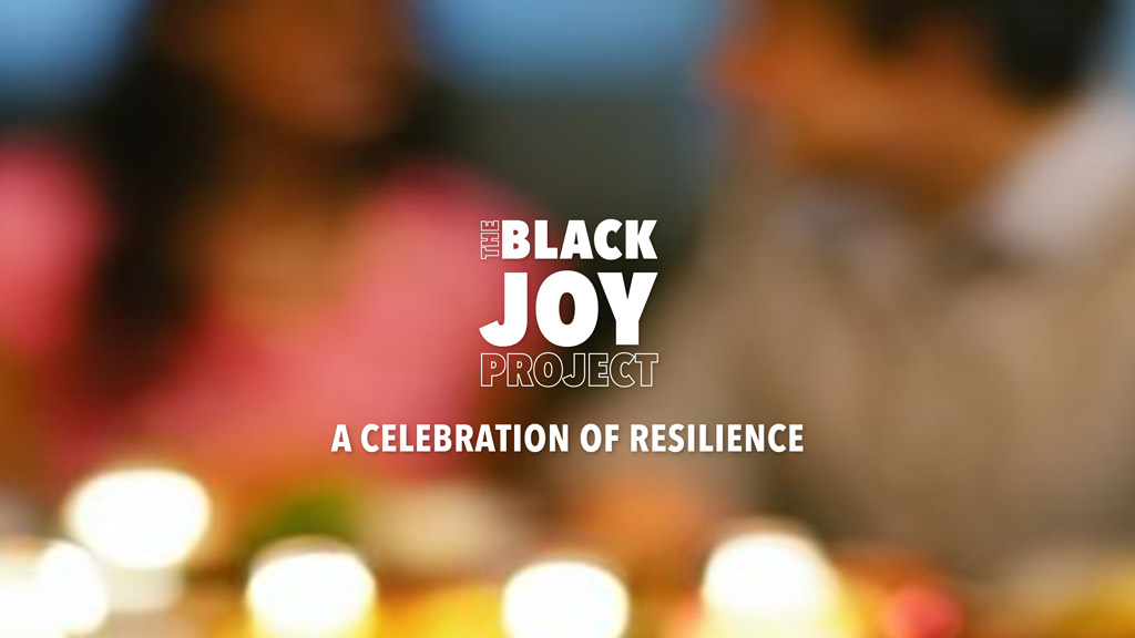 Blurred out photo of two people sitting at a table with candles, with the phrase "The Black Joy Project: A Celebration of Resilience"