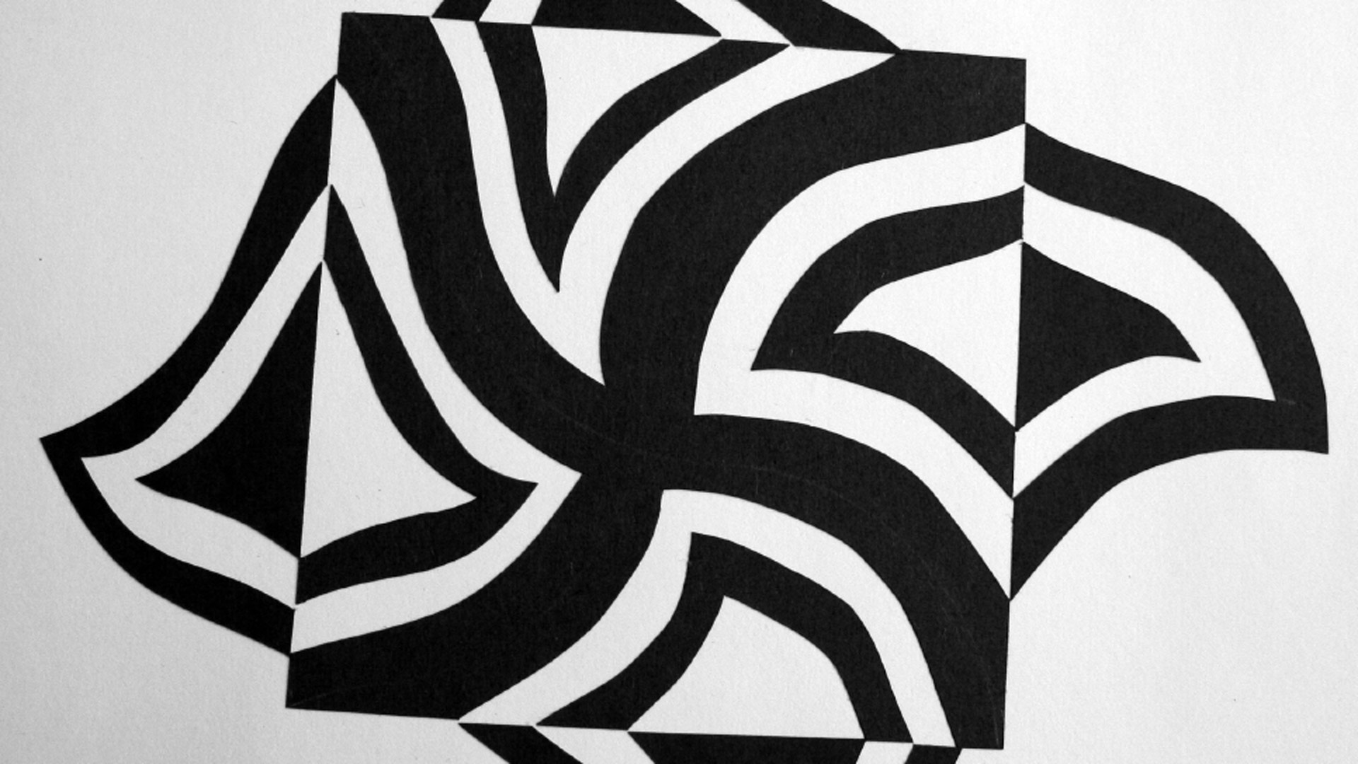 Black piece of paper on a white background with pieces of the edges cut out, reflected, and pasted