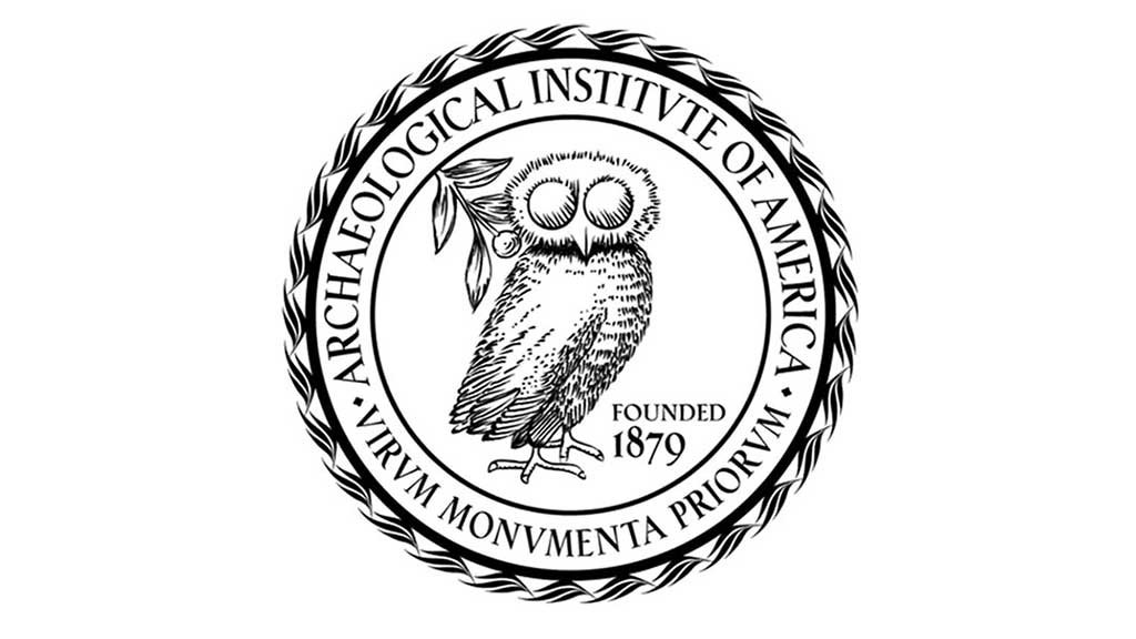 a ring structure of text with a plant and owl-like bird in the center