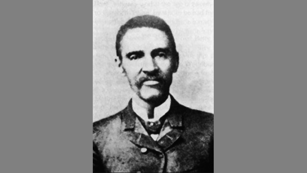 A black and white head shot of a man in Post-Civil War dress clothes.