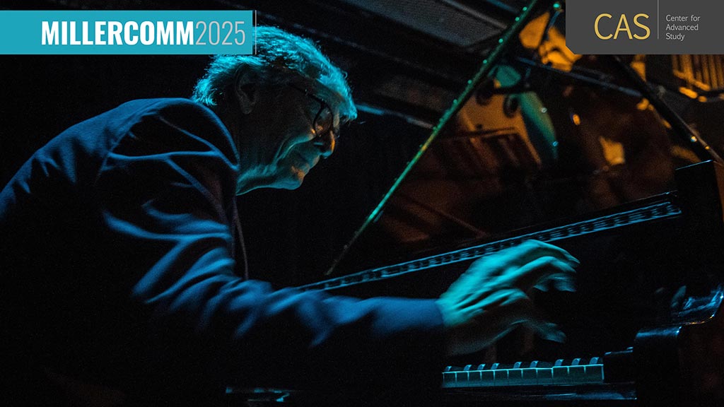a man with glasses plays piano in a dramatically lit scene with blue lighting and orange reflections