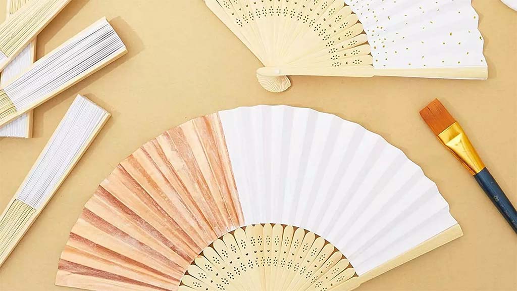 5 paper fans, both folded and unfolded, with one dry paintbrush