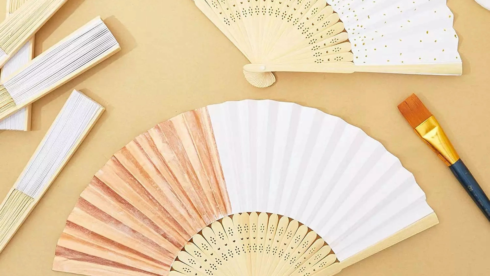 5 paper fans, both folded and unfolded, with one dry paintbrush