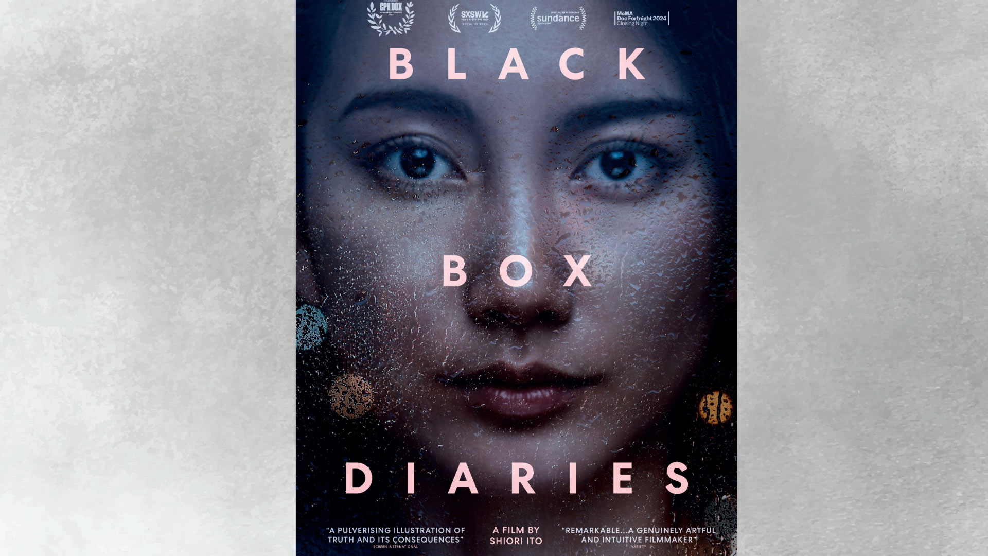 A film poster with a woman's face looking through a window with rain drops running down it with the title in pink letters on top.