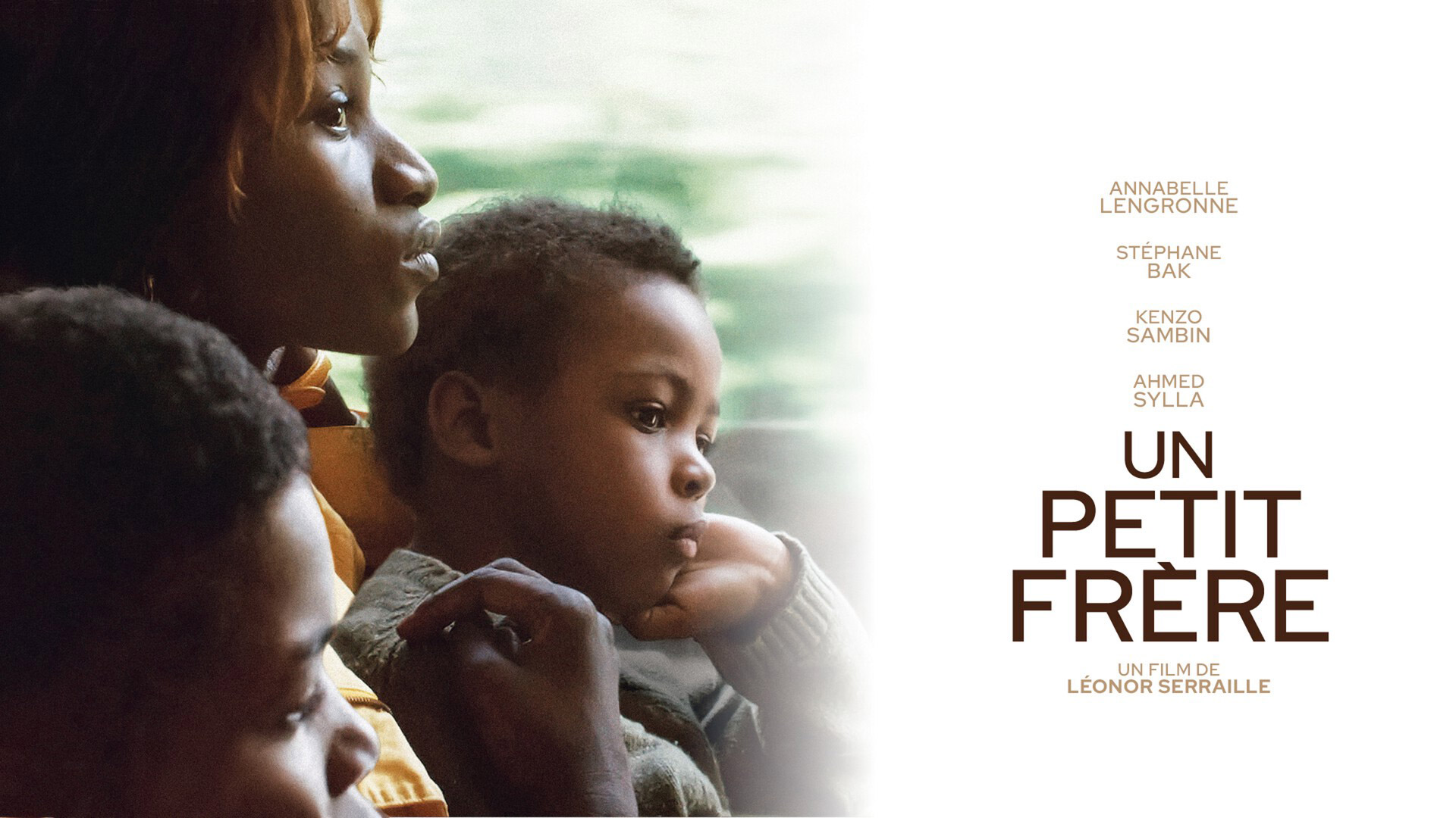 Un Petit Frére poster with a mother and her two young boys backlit from a window
