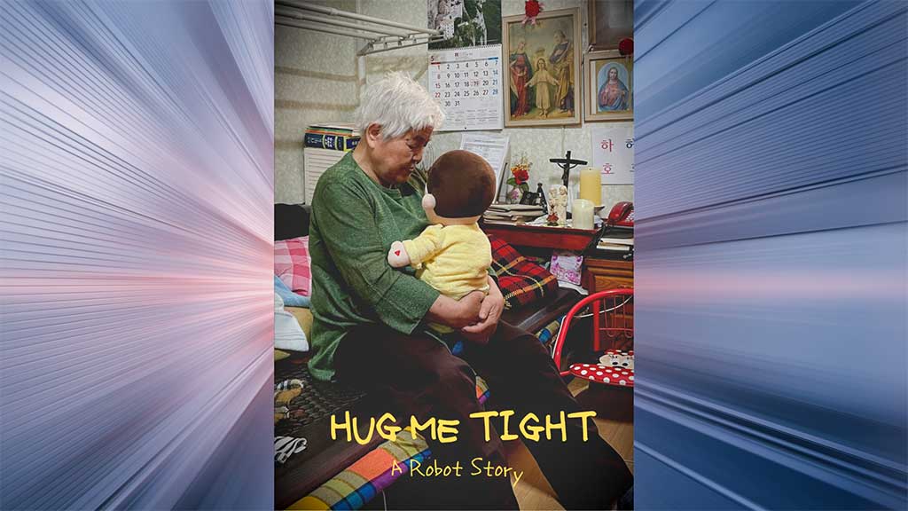 An elderly women holds a lifesize child plush doll within clutched hands on her lap in a small bedroom space