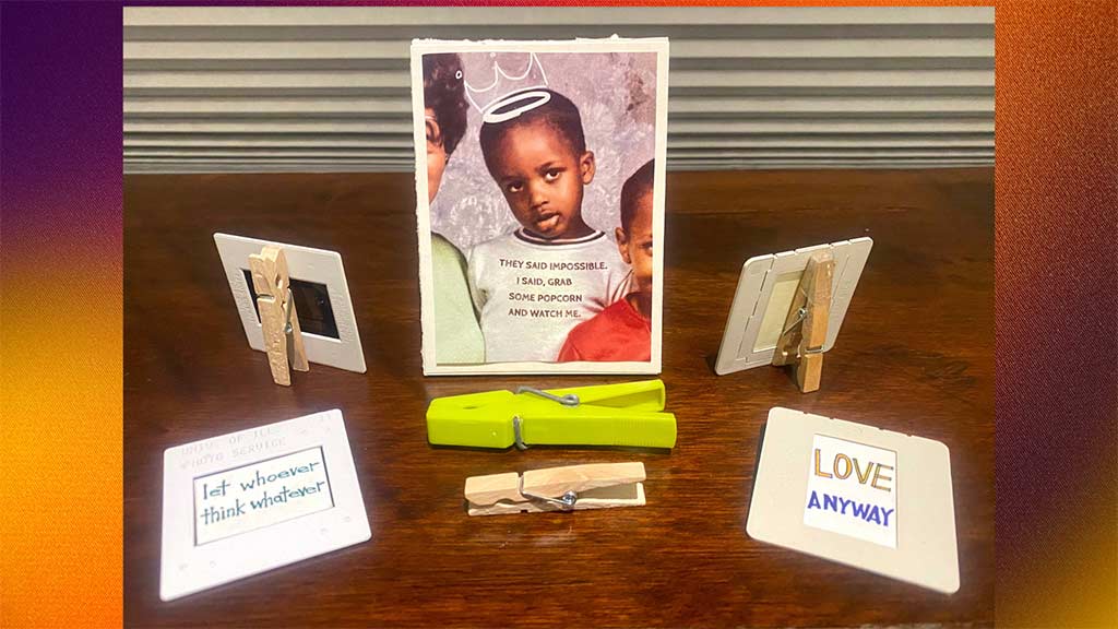 table arrangement of miniature inspirational signs and graphics using old photographic slide mounts and clothespins