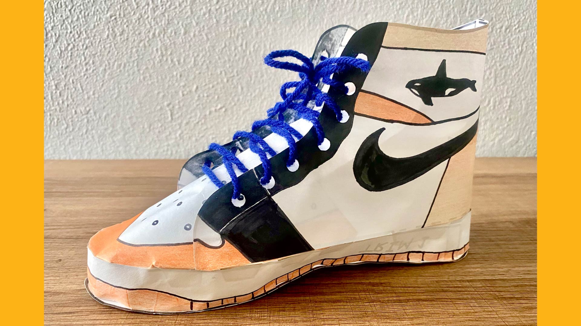 3D model of an orange and blue sneaker made out of paper